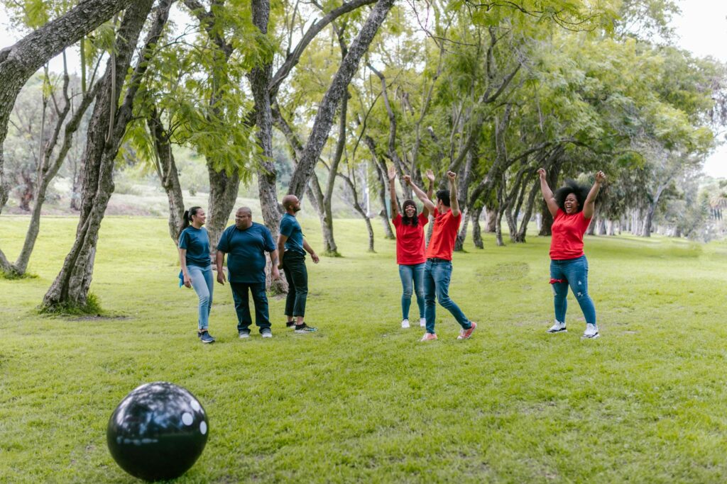 Diverse group enjoying a team-building activity outdoors, fostering fun, unity, and collaboration.